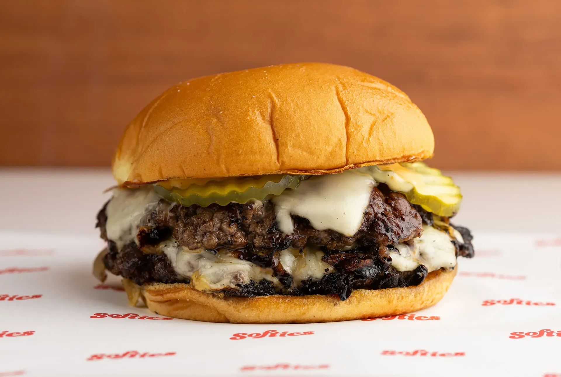Double Smashburger - hand-smashed beef patties with melted cheese, pickles, and caramelized onions
